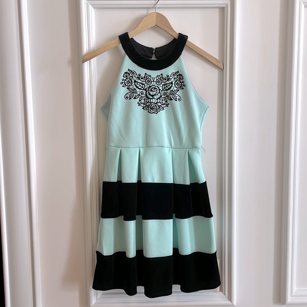 Mint green and black striped dress with cool floral pattern on top.